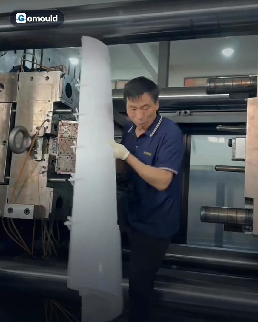 Part release: Operators at the toolmaker take long air-conditioner panels out of the mould.